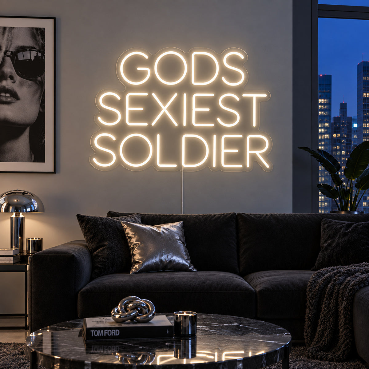 Warm White version of the Gods Sexiest Soldier Neon Sign, shown in rounded lettering above a dark sofa.