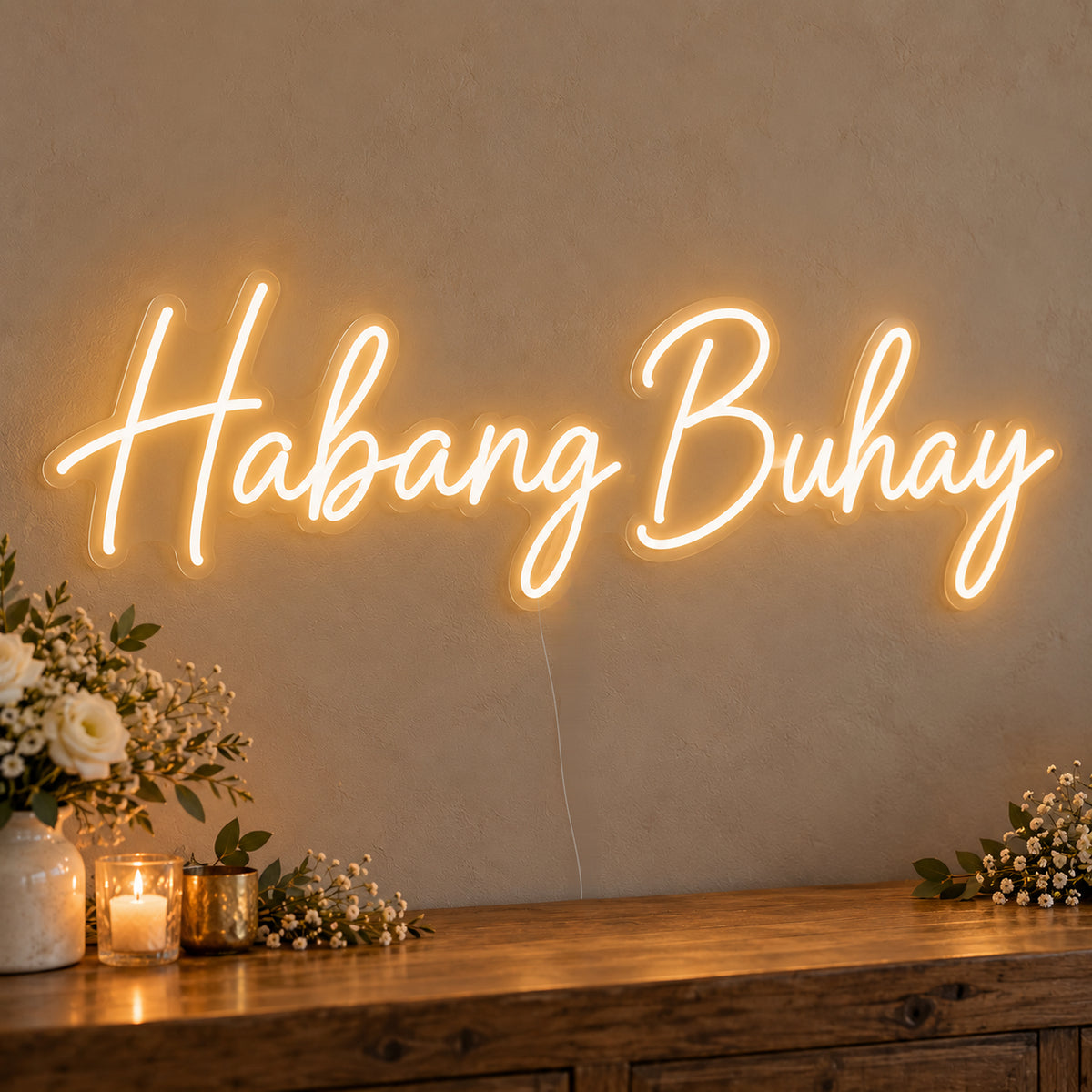 Habang Buhay Neon Sign on clear cut-to-shape acrylic, illuminated on a wall in a styled celebration setting