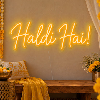 Haldi Hai Neon Sign in gold LED neon on clear acrylic, angled view