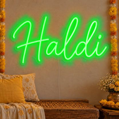 Haldi Neon Sign in green LED neon on clear acrylic, angled view