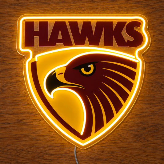 Hawthorn Hawks neon sign glowing brightly on a wooden surface in dim lighting