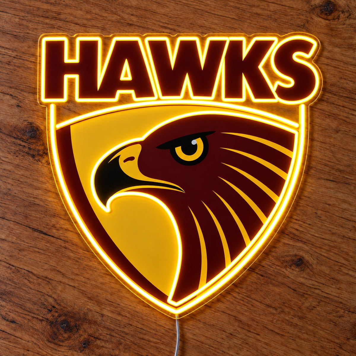 Hawthorn Hawks LED Neon Sign glowing on a wooden surface