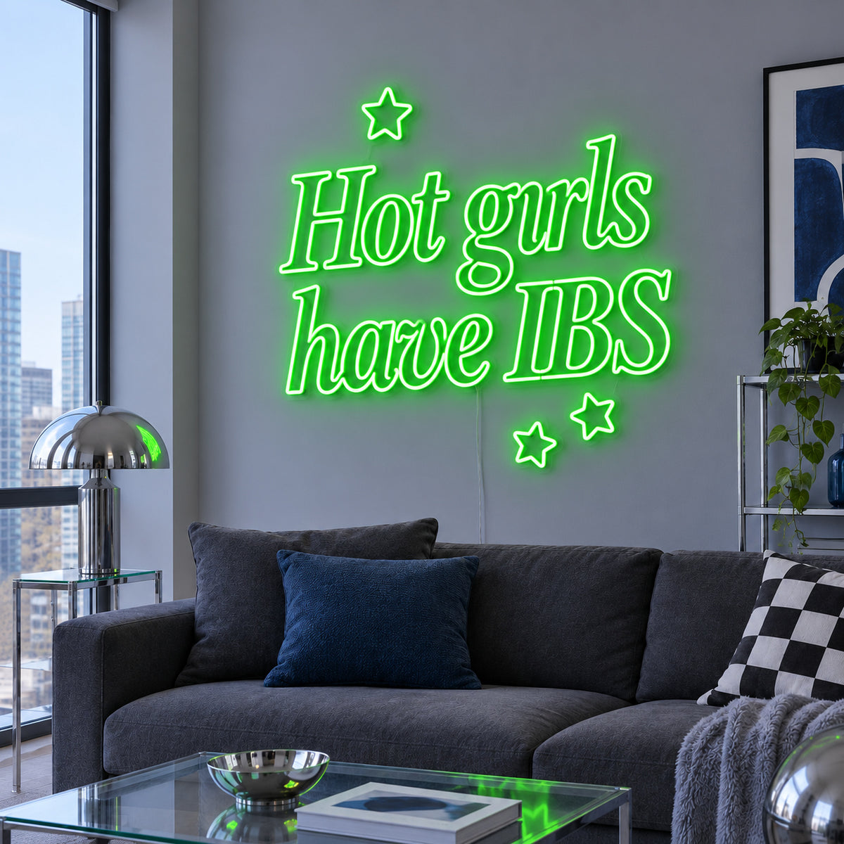 Hot Girls Have IBS Neon Sign with green lighting, displayed with star details above a charcoal sofa.