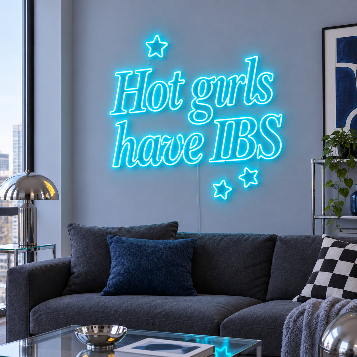 Ice Blue version of the Hot Girls Have IBS Neon Sign, shown with star details above a charcoal sofa.