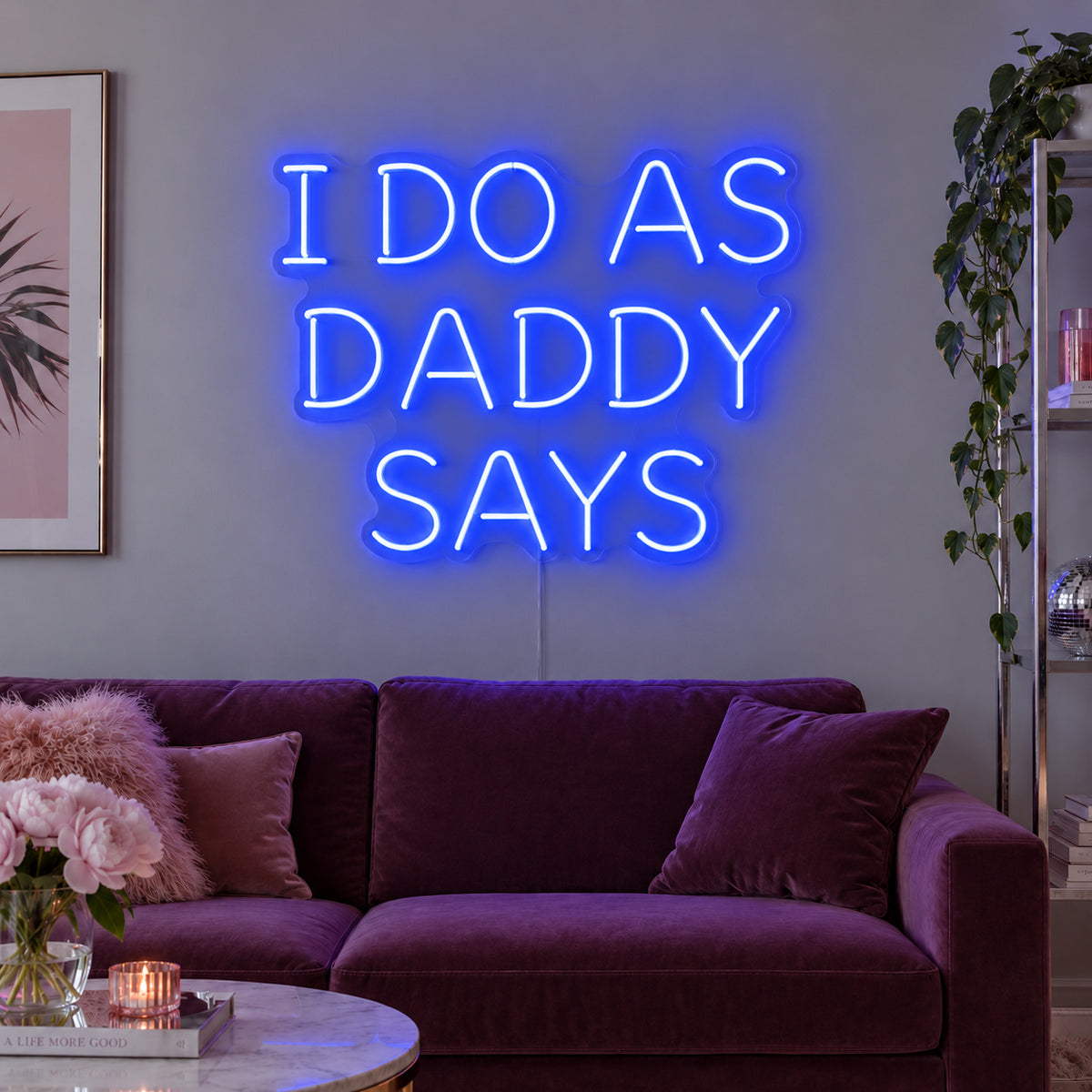 I Do As Daddy Says Neon Sign glowing blue above a burgundy sofa.