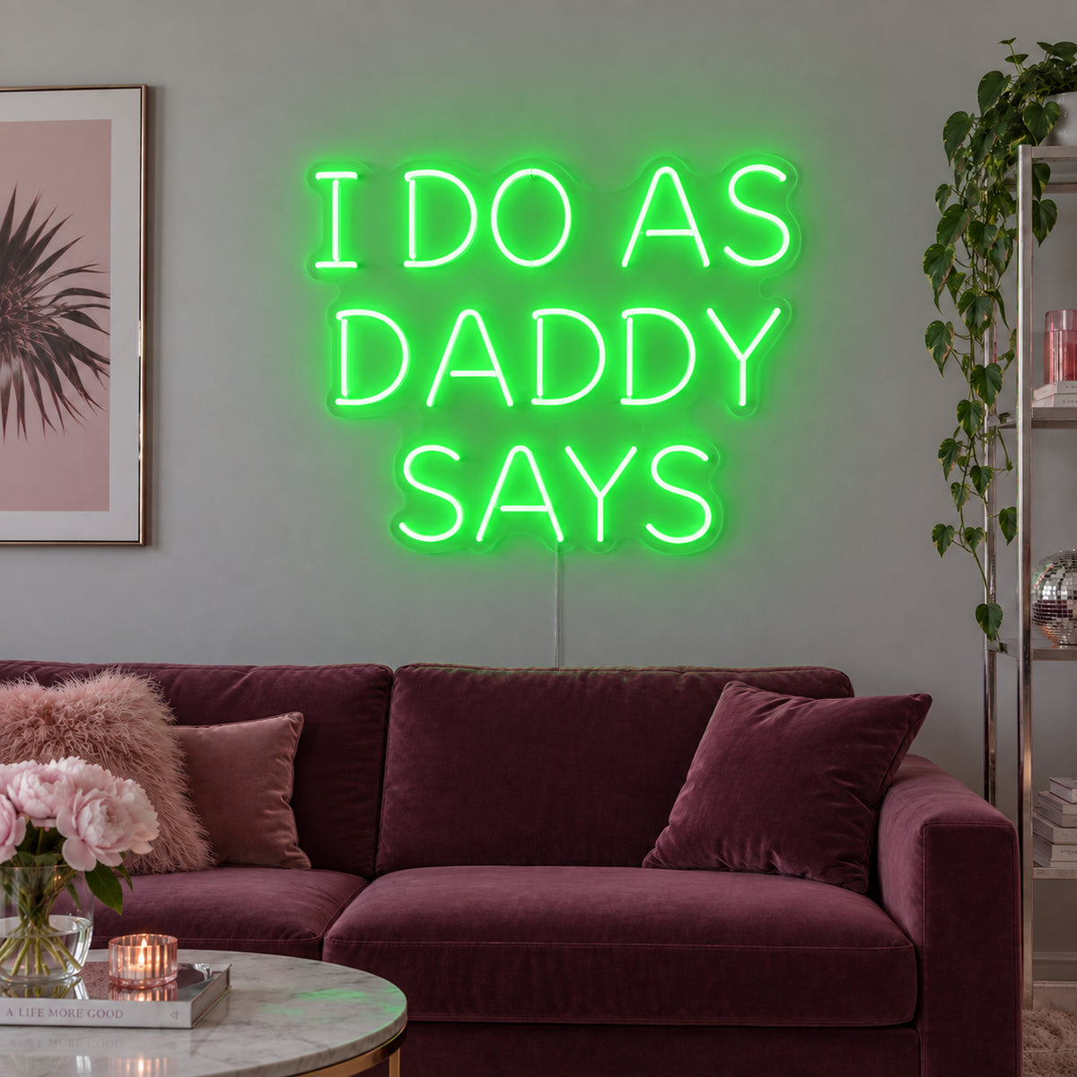 I Do As Daddy Says Neon Sign with green lighting, displayed above a burgundy sofa.