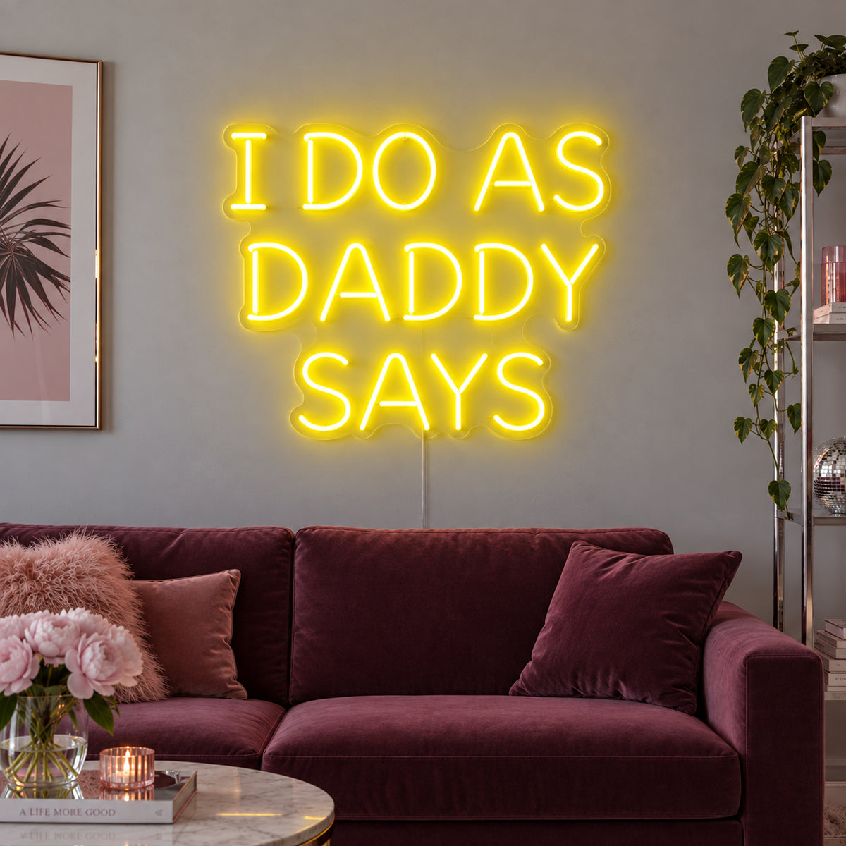 I Do As Daddy Says Neon Sign with yellow lighting, displayed above a burgundy sofa.