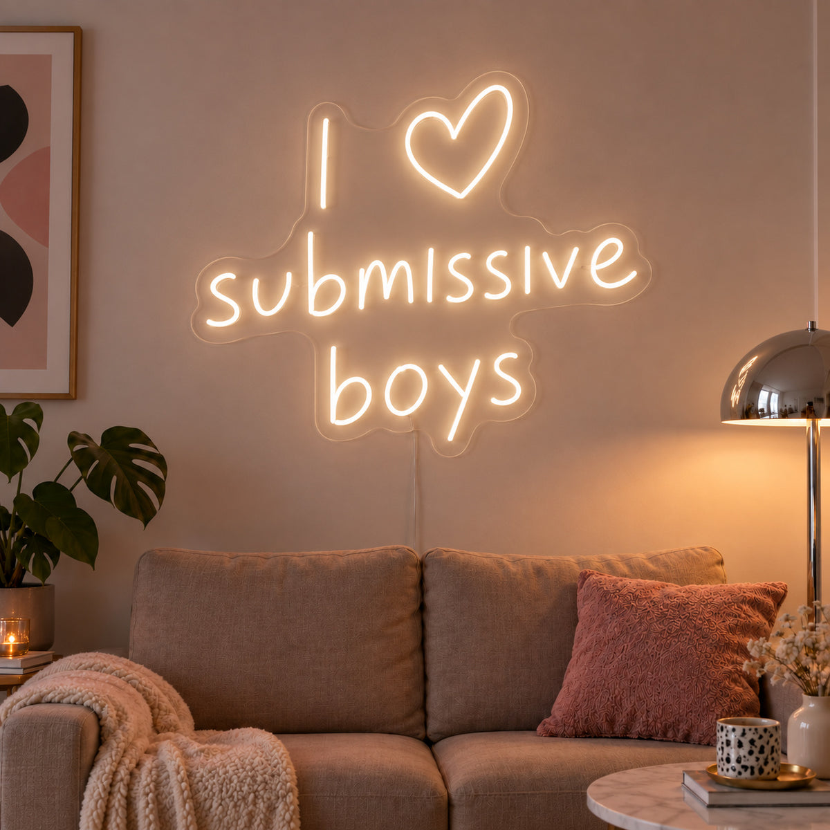 Warm White version of the I Love Submissive Boys Neon Sign, shown above a neutral sofa.