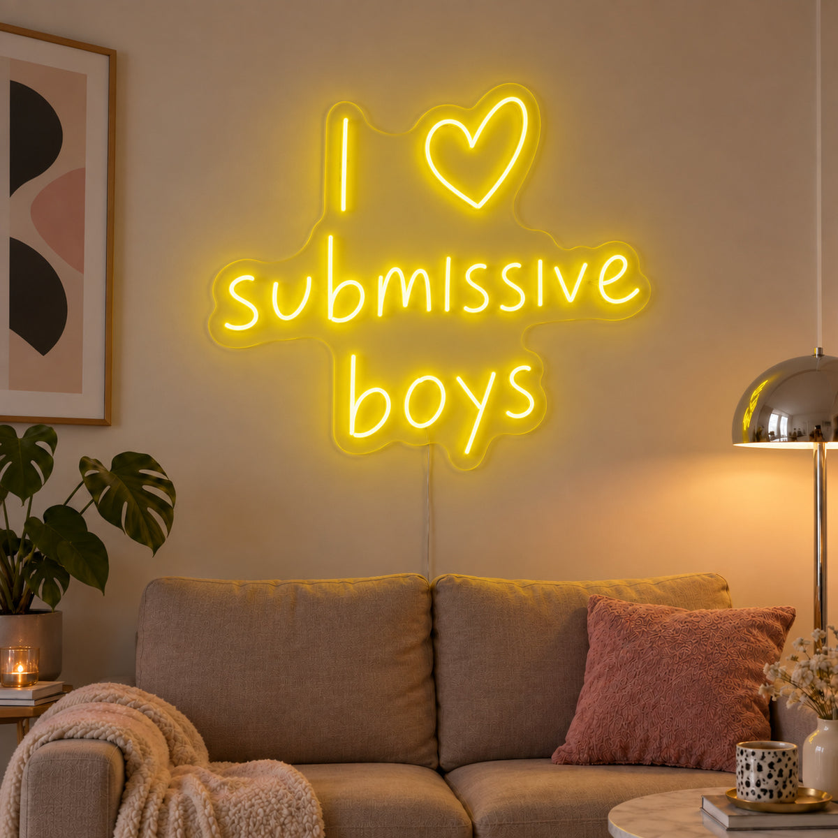 I Love Submissive Boys Neon Sign with yellow lighting, displayed above a neutral sofa.