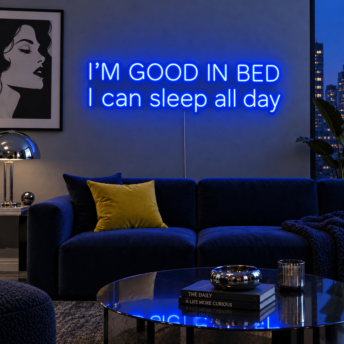 I'm Good In Bed I Can Sleep All Day Neon Sign glowing blue above a navy sofa.