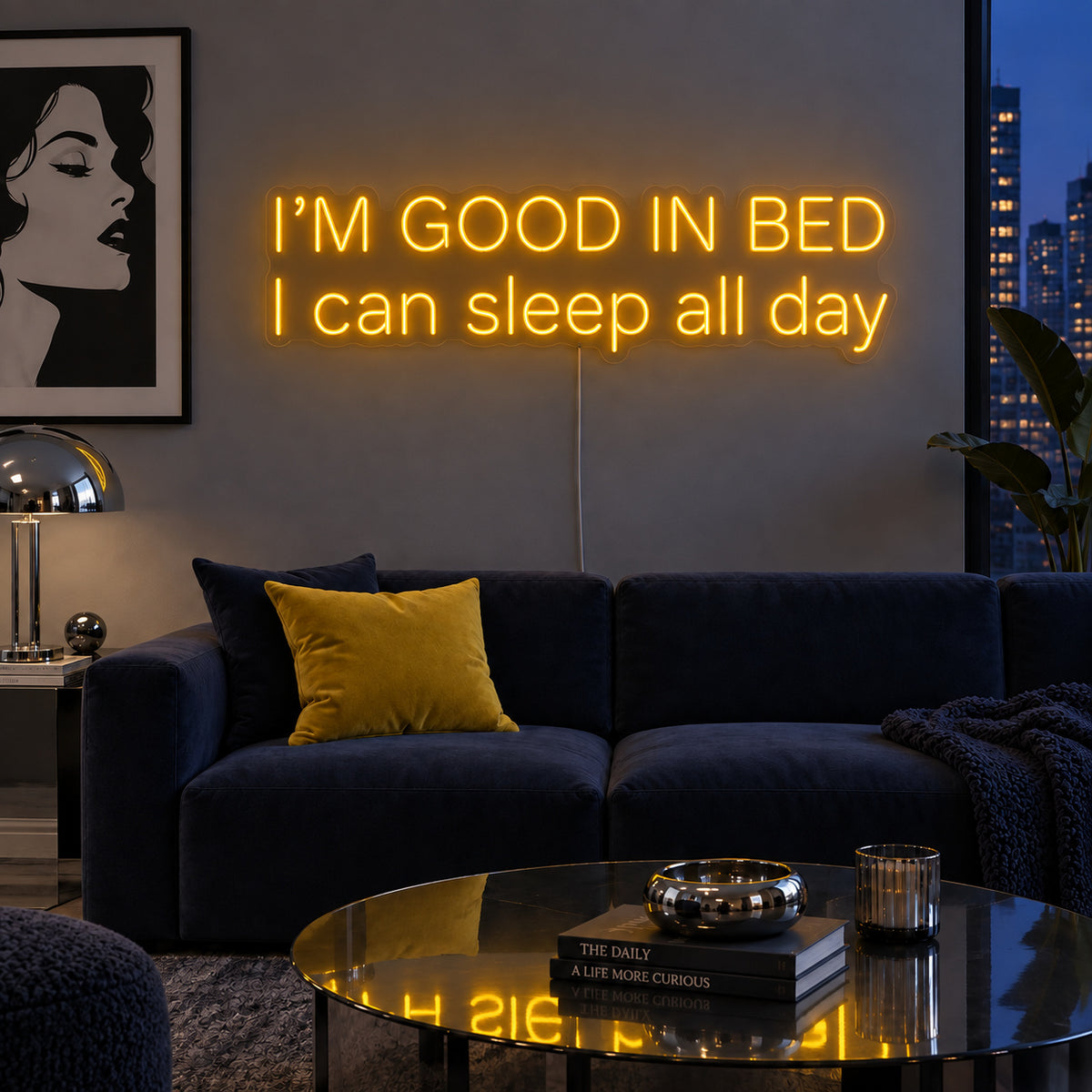 I'm Good In Bed I Can Sleep All Day Neon Sign glowing gold above a navy sofa.