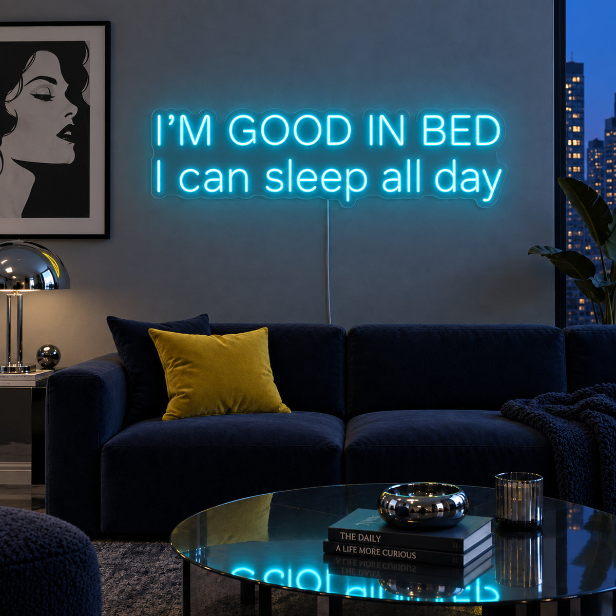 Ice Blue version of the I'm Good In Bed I Can Sleep All Day Neon Sign, shown above a navy sofa.