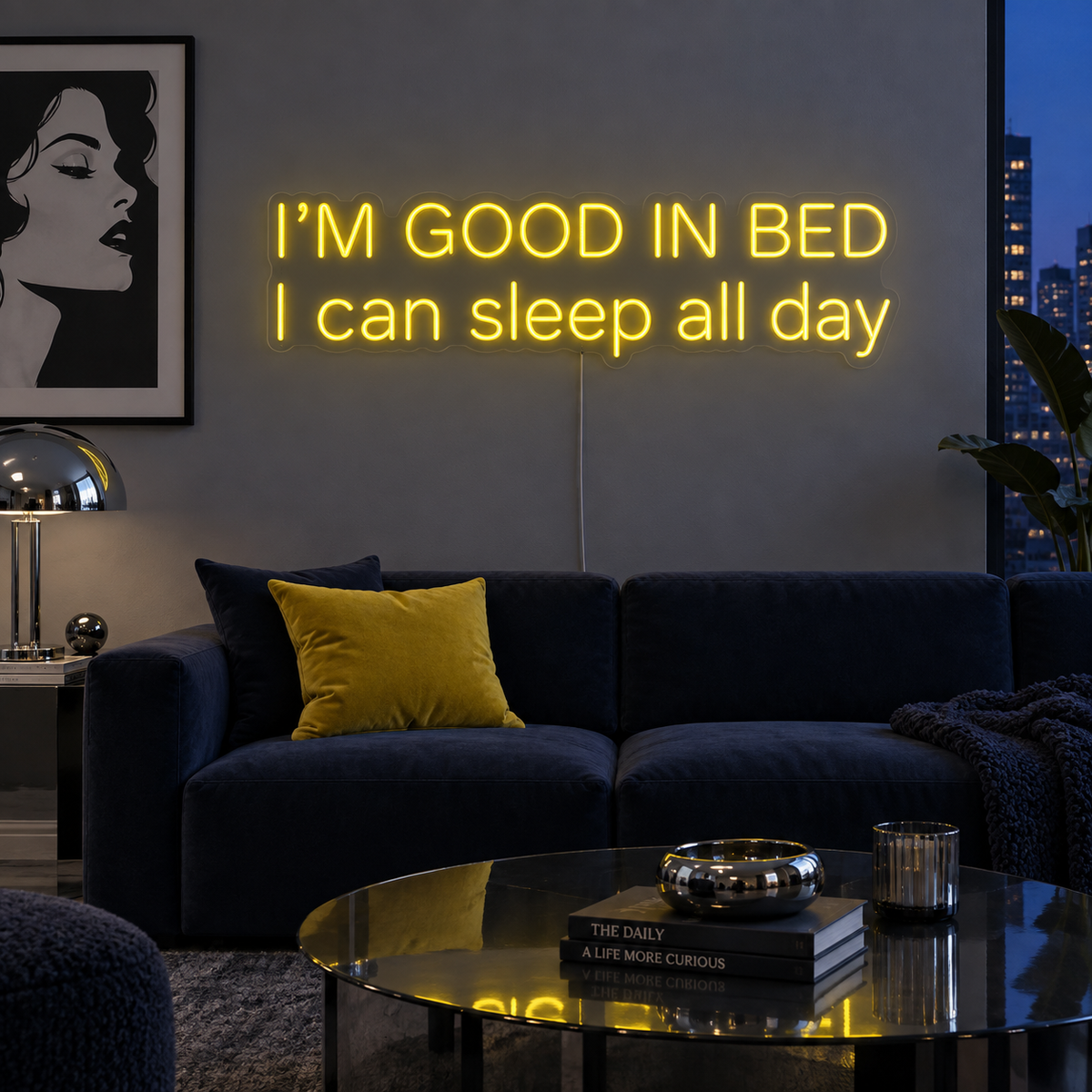 I'm Good In Bed I Can Sleep All Day Neon Sign in yellow above a navy sofa.