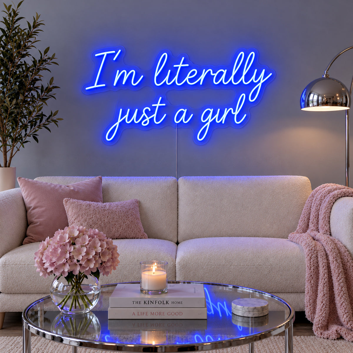 I'm Literally Just A Girl Neon Sign glowing blue above a cream sofa.