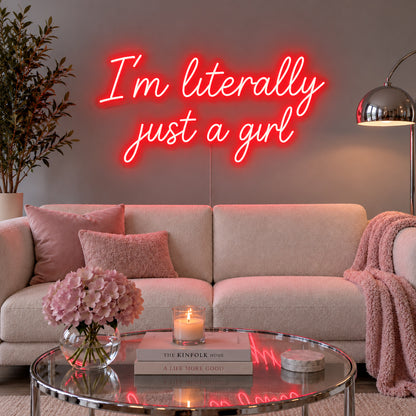 I'm Literally Just A Girl Neon Sign with red lighting, displayed above a cream sofa.