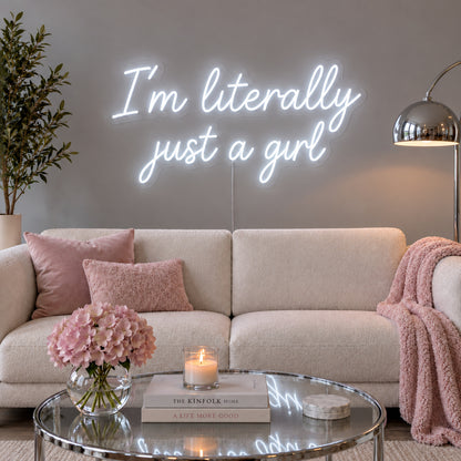 I'm Literally Just A Girl Neon Sign, RGB colour-changing option shown in white above a cream sofa.
