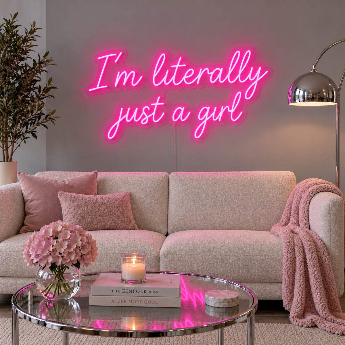 Rose Red version of the I'm Literally Just A Girl Neon Sign, shown above a cream sofa.