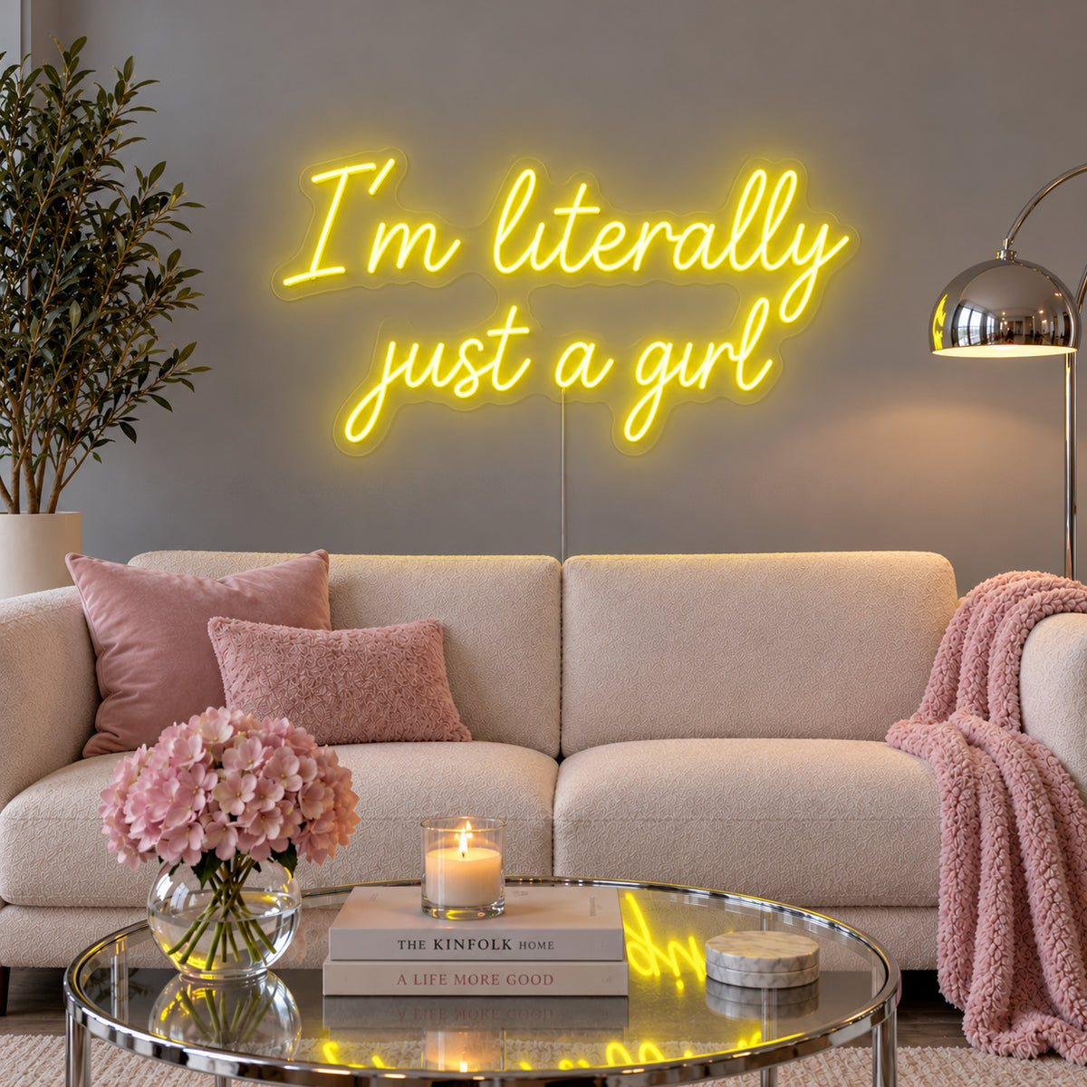 I'm Literally Just A Girl Neon Sign with yellow lighting, displayed above a cream sofa.