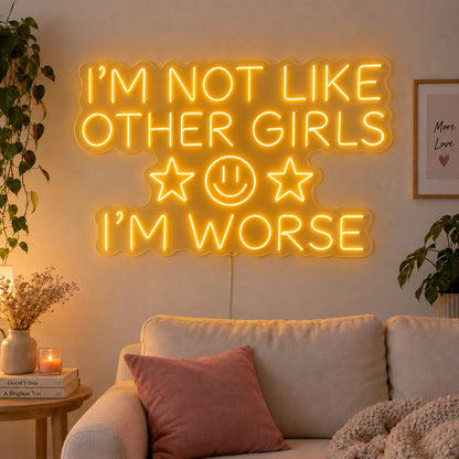 I'm Not Like Other Girls I'm Worse Neon Sign glowing gold with stars and a smiley face above a cream sofa.