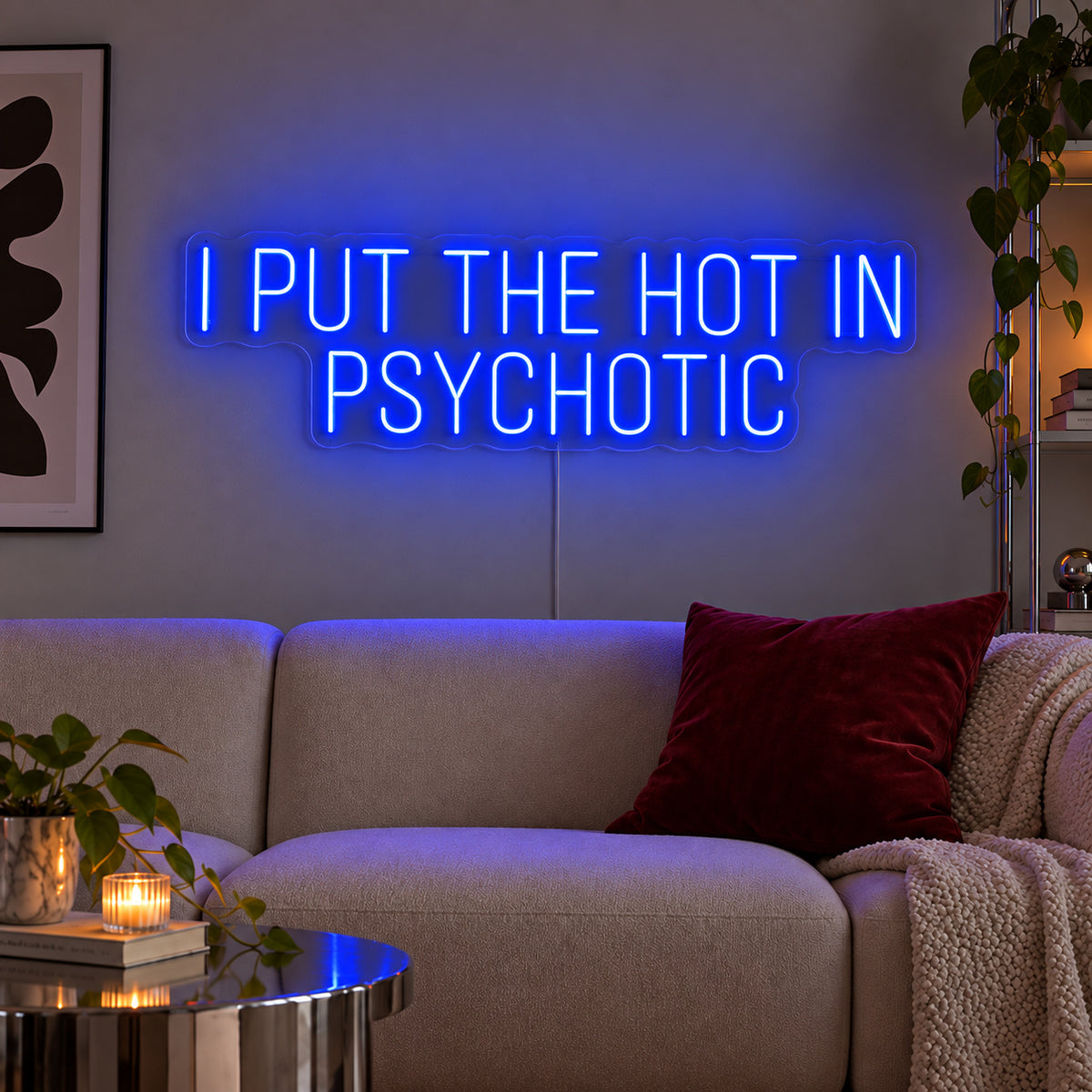 I Put The Hot In Psychotic Neon Sign glowing blue above a neutral sofa.