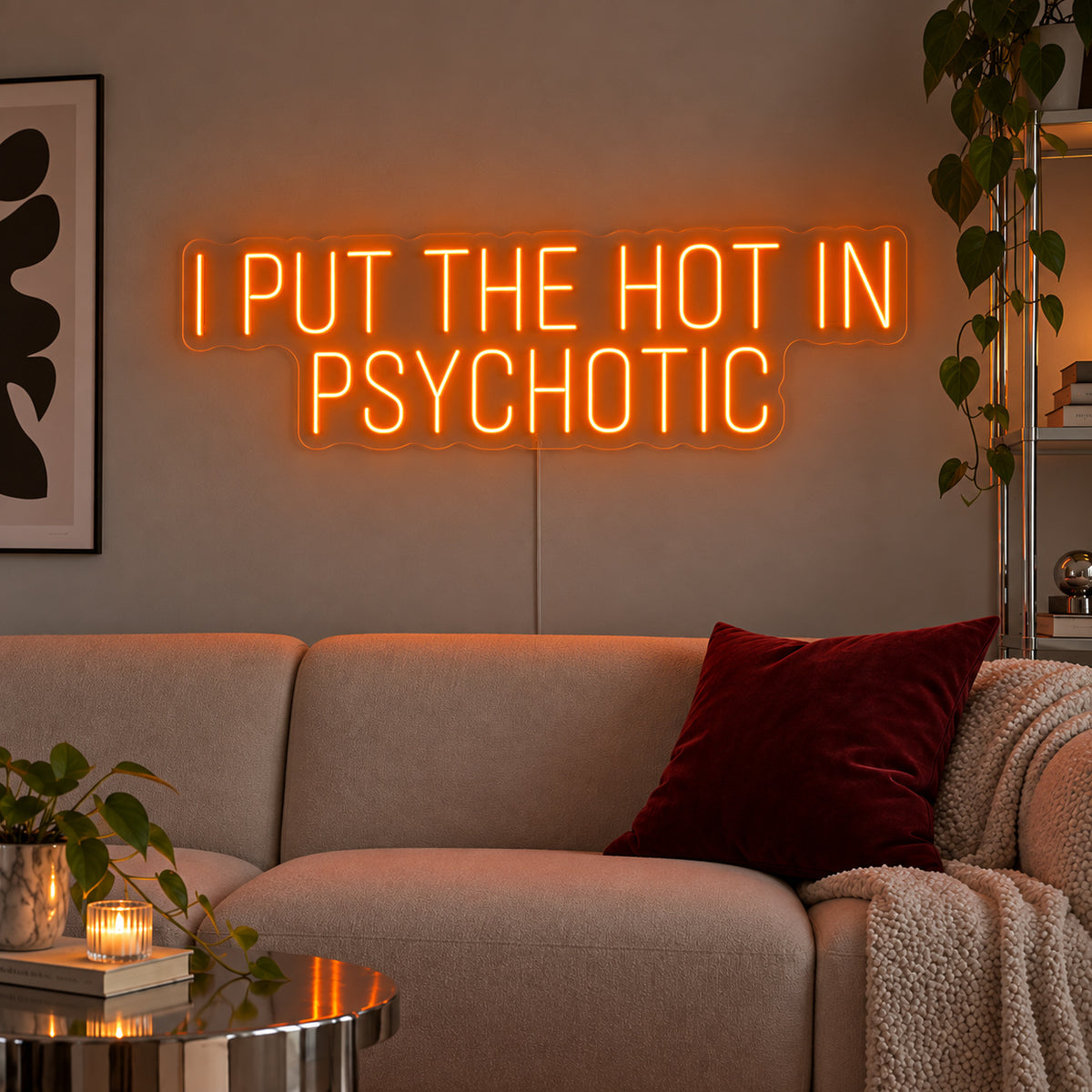 Orange version of the I Put The Hot In Psychotic Neon Sign, shown above a neutral sofa.