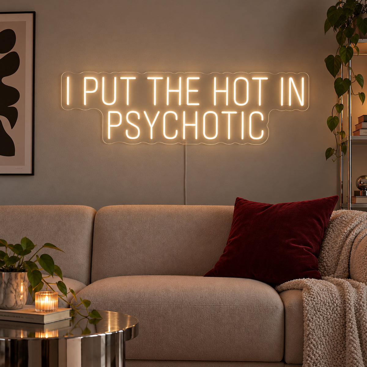 Warm White version of the I Put The Hot In Psychotic Neon Sign, shown above a neutral sofa.