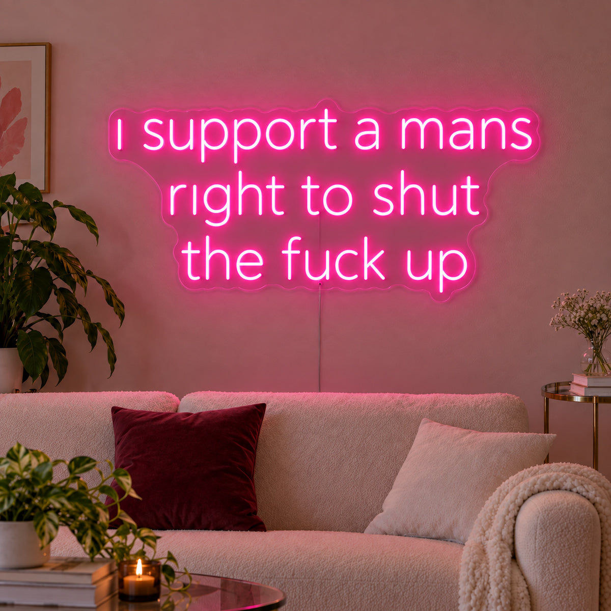 Rose Red version of the I Support A Mans Right To Shut The Fuck Up Neon Sign, shown above a cream sofa.