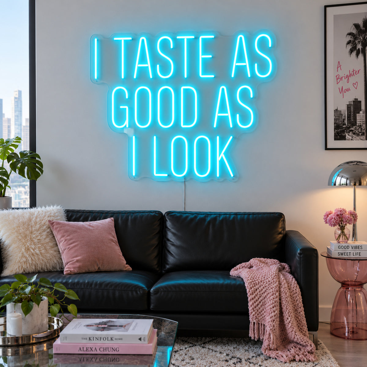Ice Blue version of the I Taste As Good As I Look Neon Sign, shown above a black sofa.