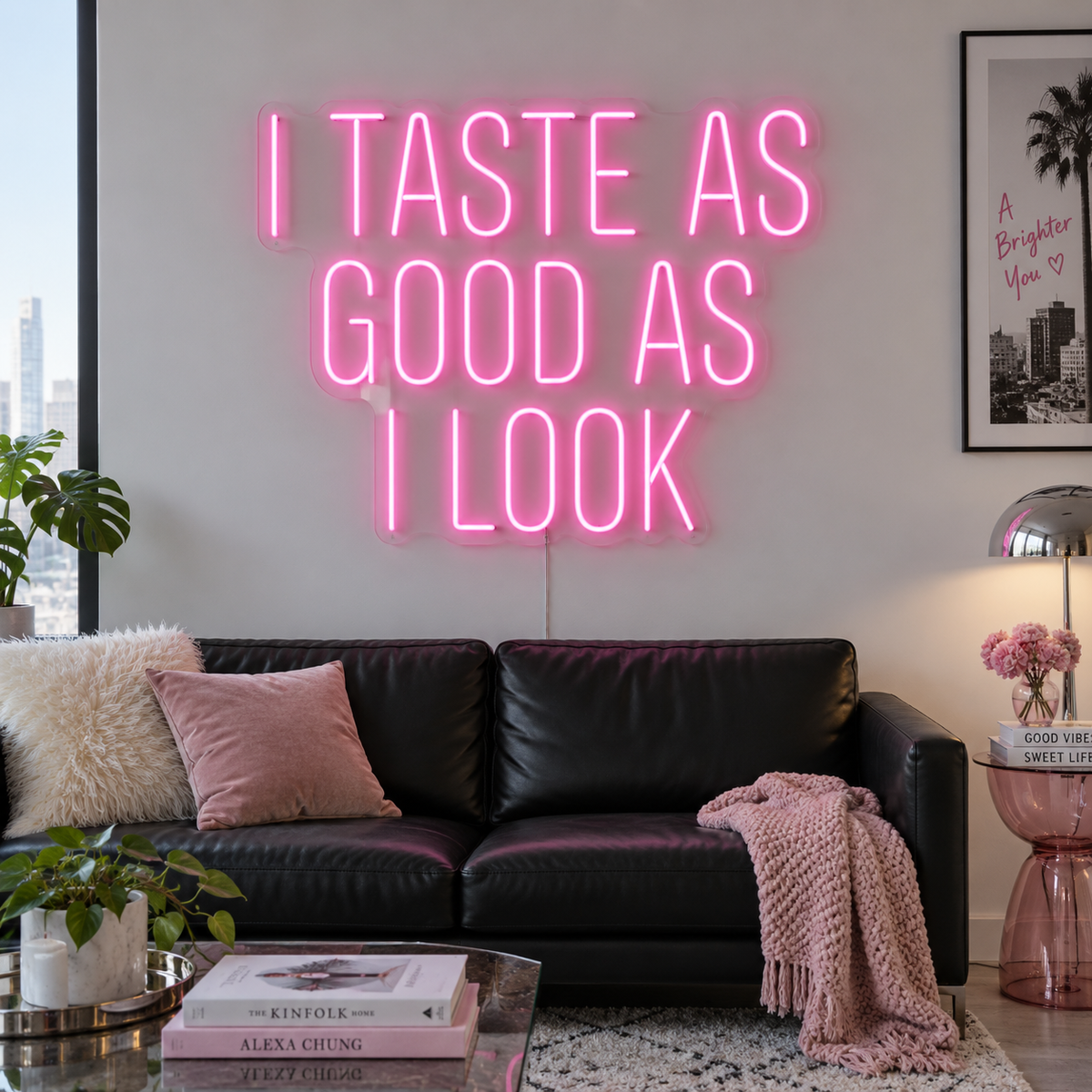 I Taste As Good As I Look Neon Sign in pink above a black sofa.