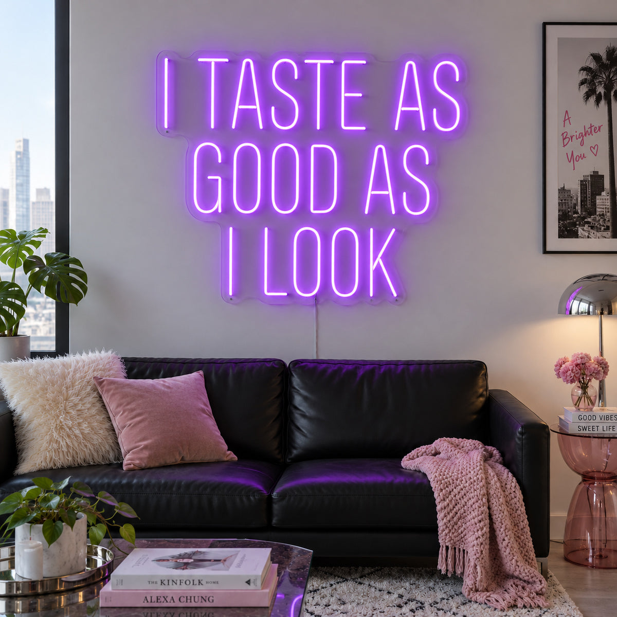 I Taste As Good As I Look Neon Sign with purple lighting, displayed above a black sofa.