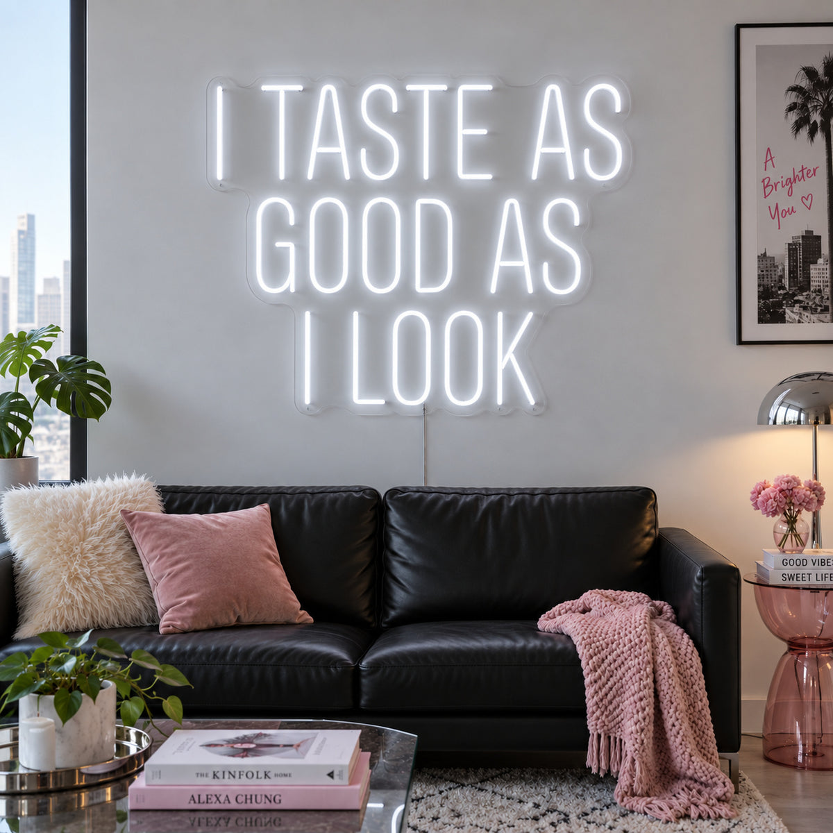I Taste As Good As I Look Neon Sign glowing white above a black sofa.
