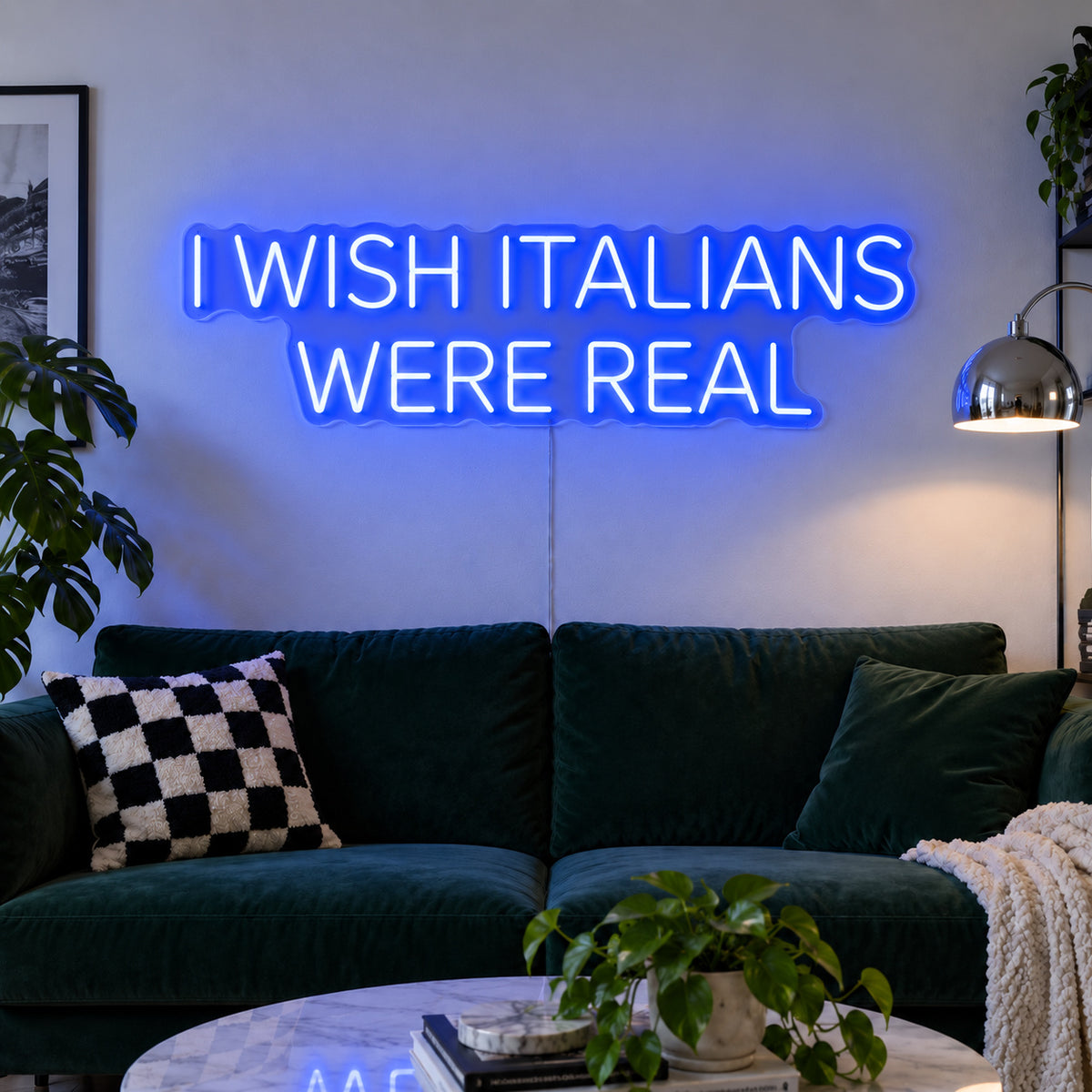 I Wish Italians Were Real Neon Sign glowing blue above a green sofa.