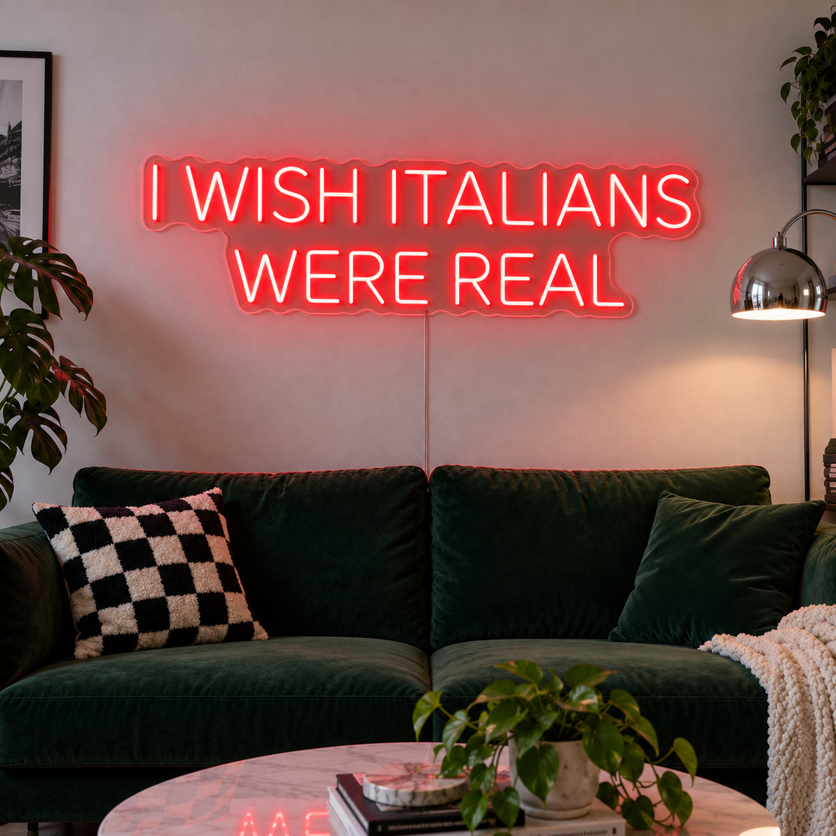 I Wish Italians Were Real Neon Sign with red lighting, displayed above a green sofa.