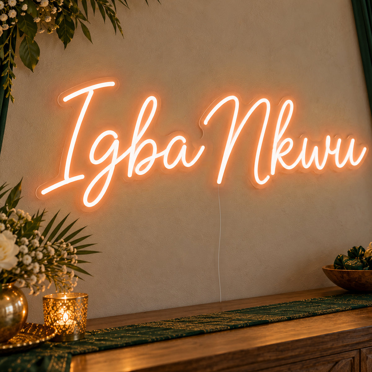 Igba Nkwu Neon Sign in orange LED neon on clear acrylic, angled view