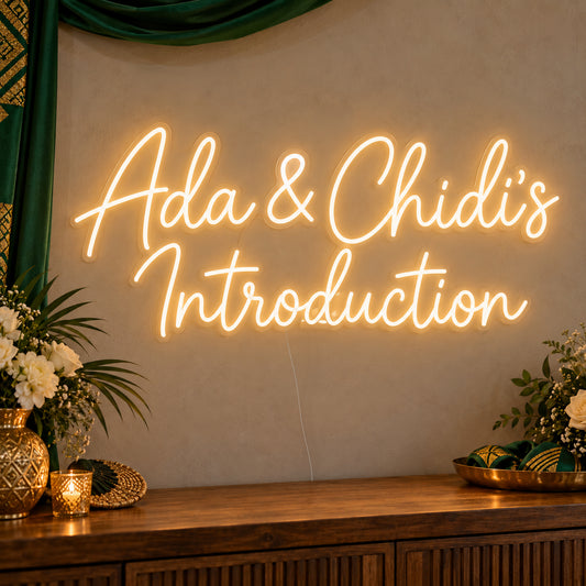 Personalised Introduction Neon Sign on clear cut-to-shape acrylic, illuminated on a wall in a styled celebration setting; sample personalised wording shown