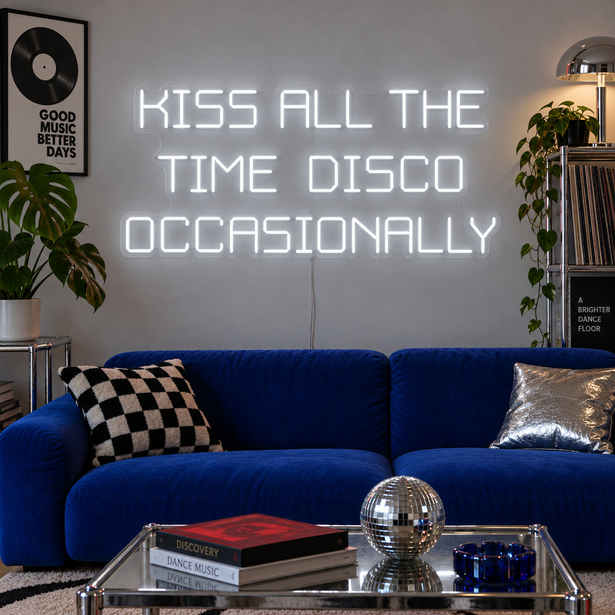 Kiss All The Time Disco Occasionally Neon Sign, RGB colour-changing option shown in white above a blue sofa near a disco ball.