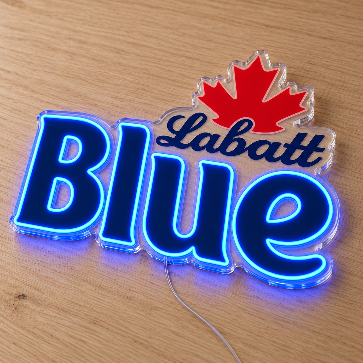Labatt Blue LED neon sign on a light wooden surface, second angled view