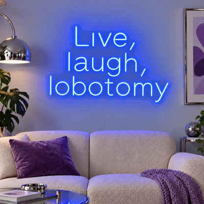 Live, Laugh, Lobotomy Neon Sign glowing blue above a cream sofa with purple cushions.