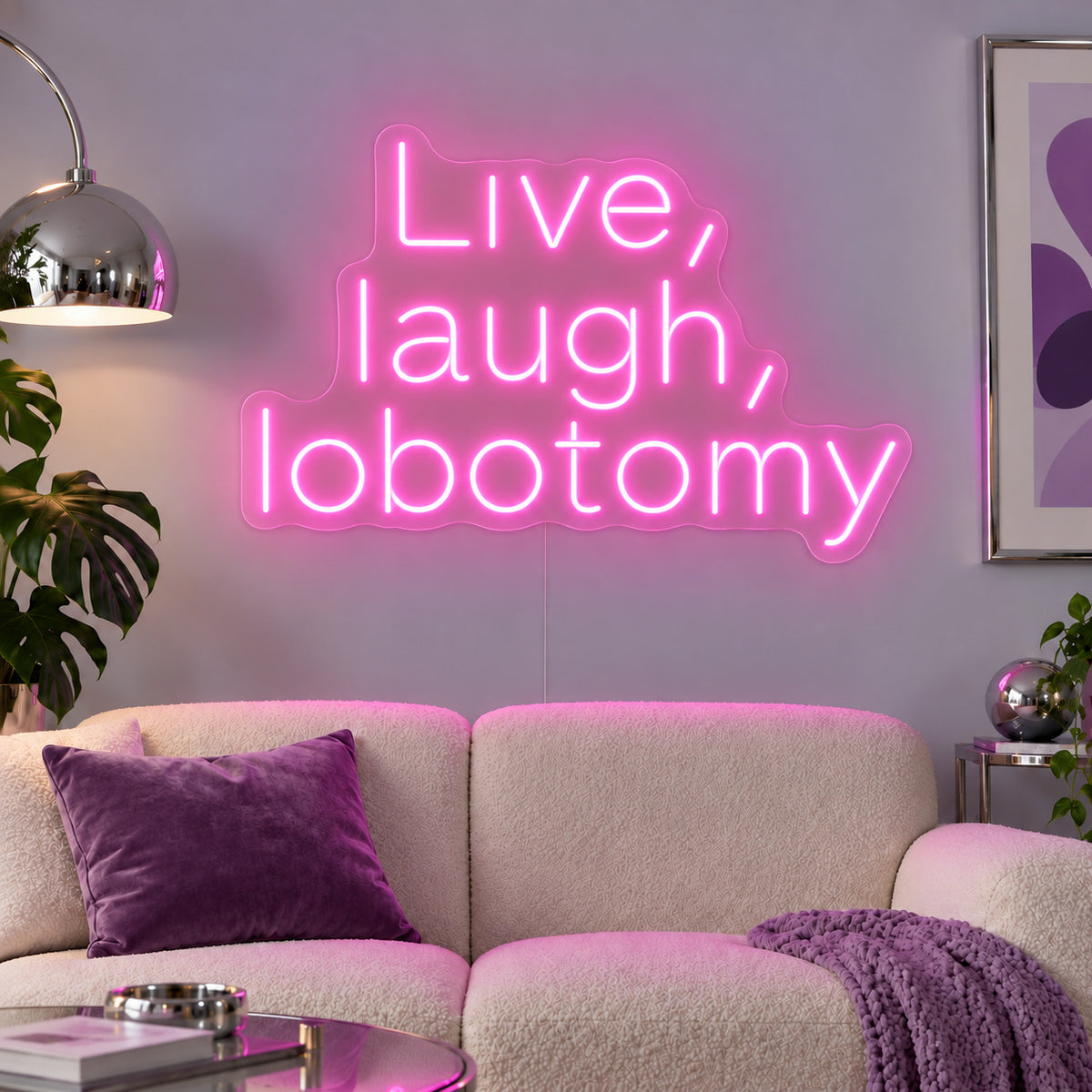 Live, Laugh, Lobotomy Neon Sign glowing pink above a cream sofa with purple cushions.