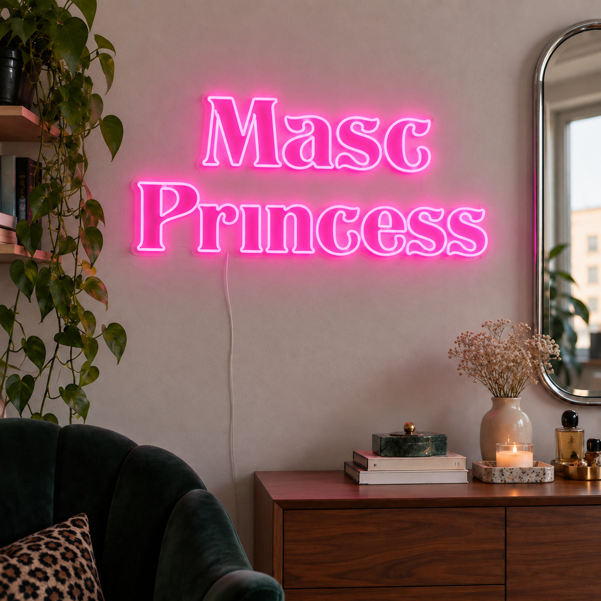 Masc Princess Neon Sign glowing pink above a wooden sideboard beside a green chair.