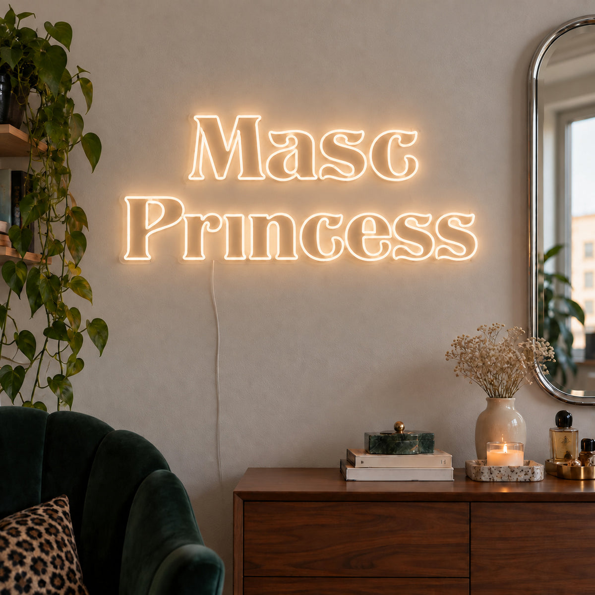 Warm White version of the Masc Princess Neon Sign, shown above a wooden sideboard beside a green chair.