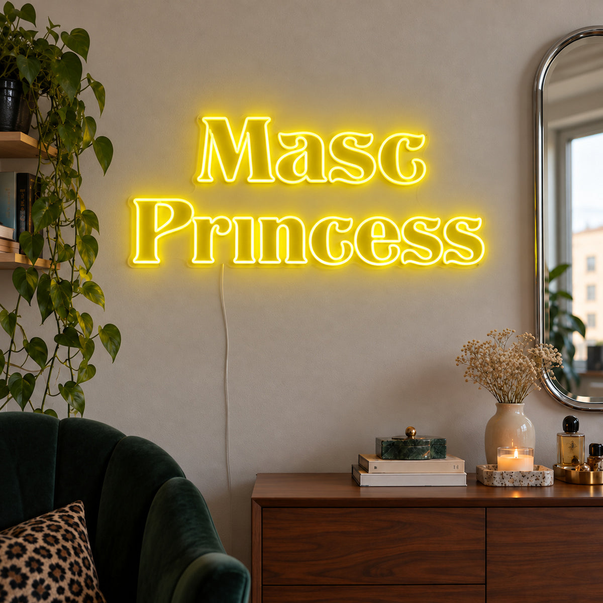 Masc Princess Neon Sign with yellow lighting, displayed above a wooden sideboard beside a green chair.