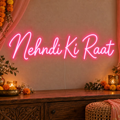 Mehndi Ki Raat Neon Sign on clear cut-to-shape acrylic, illuminated on a wall in a styled celebration setting