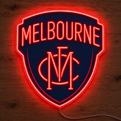 Melbourne Demons Neon Sign glowing bright red on a wooden surface in dimmed room lighting