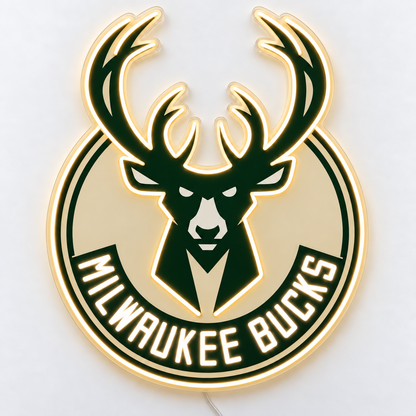 Milwaukee Bucks neon sign on a white surface, with warm white antler and deer head outlines, green and cream artwork and a thin wire emerging from behind.