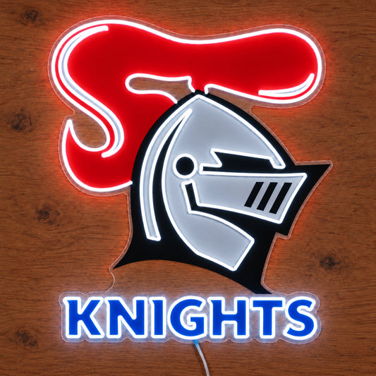 Newcastle Knights neon sign glowing brightly on a wooden surface in dim lighting