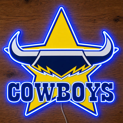 North Queensland Cowboys neon sign glowing brightly on a wooden surface in dim lighting