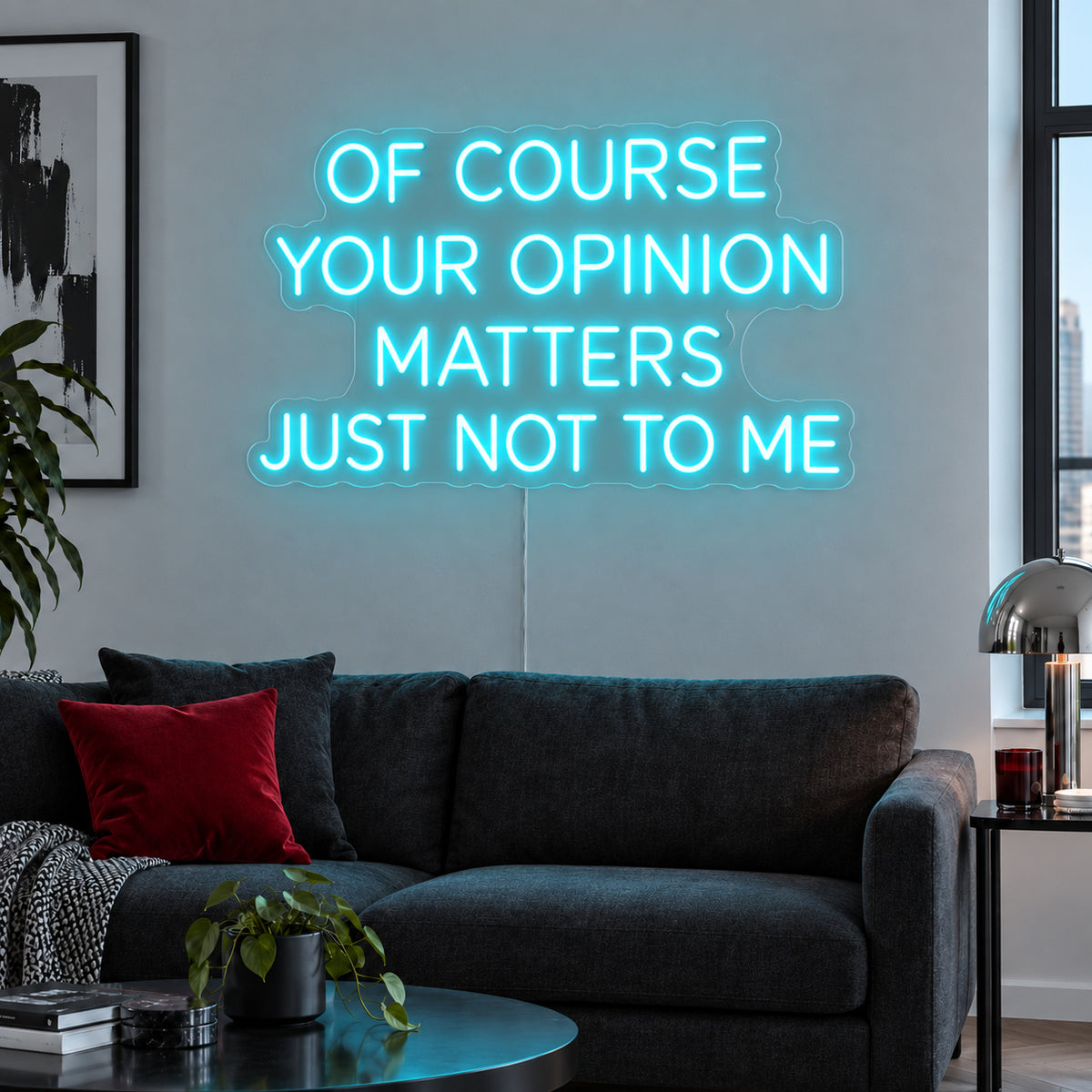 Ice Blue version of the Of Course Your Opinion Matters Just Not To Me Neon Sign, shown above a black sofa.
