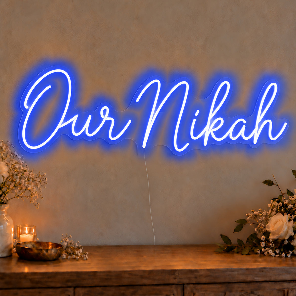 Our Nikah Neon Sign in blue LED neon on clear acrylic, angled view