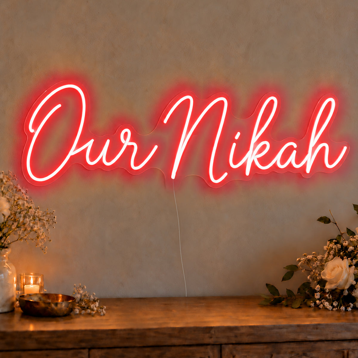 Our Nikah Neon Sign in red LED neon on clear acrylic, angled view